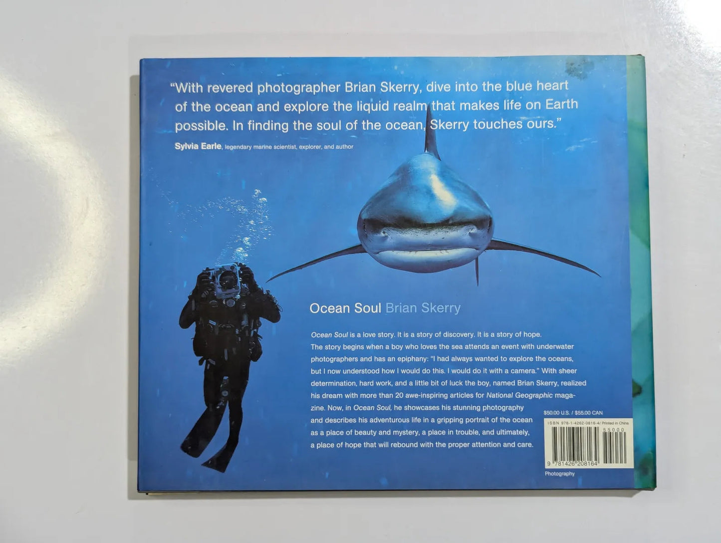 Book cover with a diver and fish illustration on a blue background