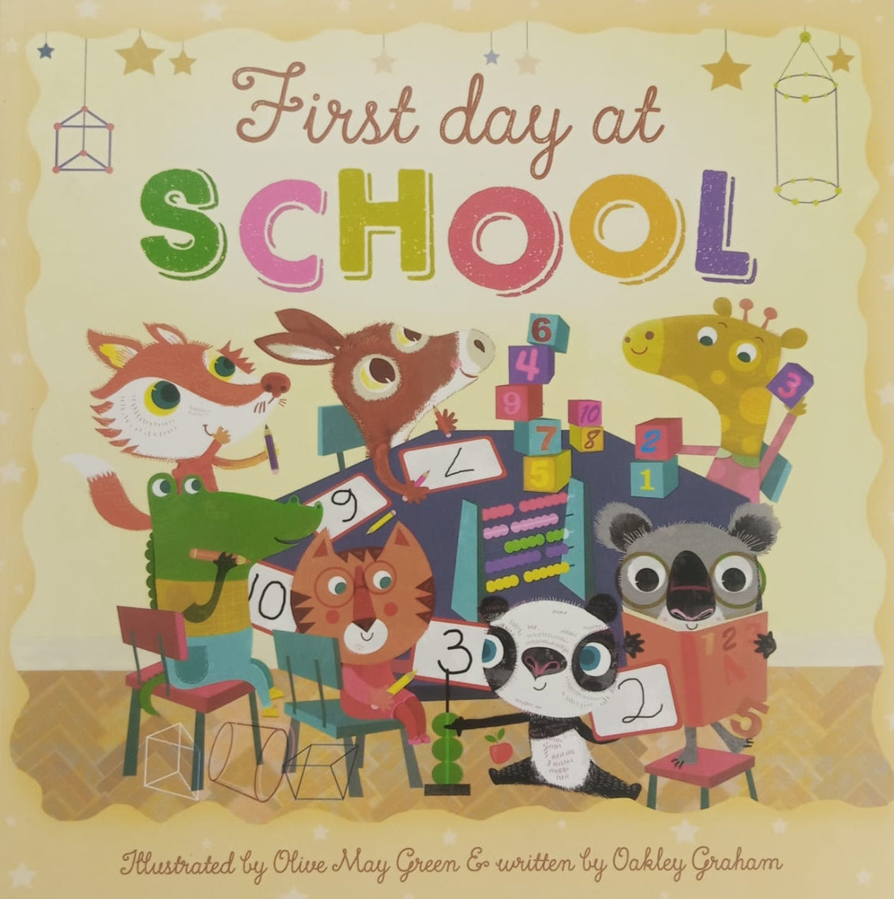 Cover of a children book titled 'First day at SCHOOL', featuring illustrations of various animals and school-related items.