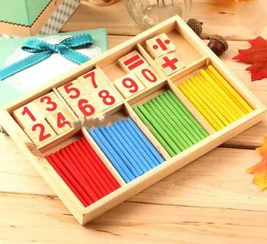 Mathematical educational toy set with numbers and colored sticks on a wooden surface