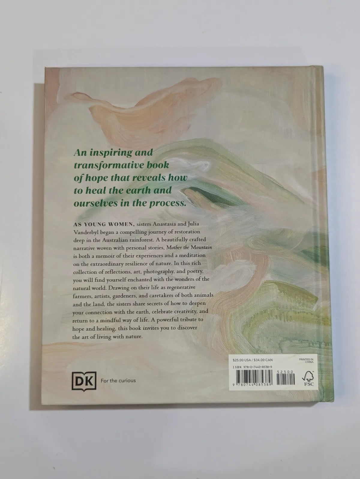 Back cover of a book with text and a landscape illustration on a light gray background