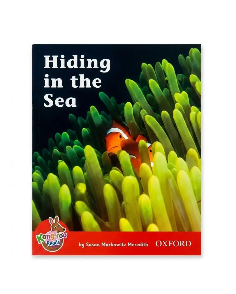 Children's book cover titled 'Hiding in the Sea' featuring a clownfish among green anemones. The cover has a red band at the bottom with the Oxford logo and Kangaroo Books logo.
