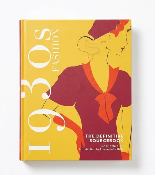 A hardcover book titled "1930s Fashion: The Definitive Sourcebook" by Charlotte Fiels, featuring a bold retro illustration of a woman in a maroon dress and hat on a yellow cover, photographed against a clean white background.