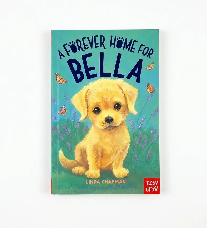 A children's book titled "A Forever Home for Bella" by Linda Chapman, featuring an illustration of a fluffy yellow puppy on a teal background with butterflies and purple flowers. The book is published by Nosy Crow and is photographed against a clean white background.
