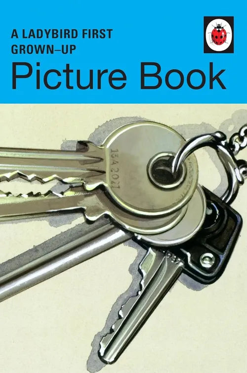 Keychain with keys on a beige background, featuring the Ladybird Books logo.