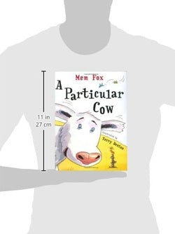 Book titled 'A Particular Cow' by Terry Pratchett held by a person, with dimensions displayed.