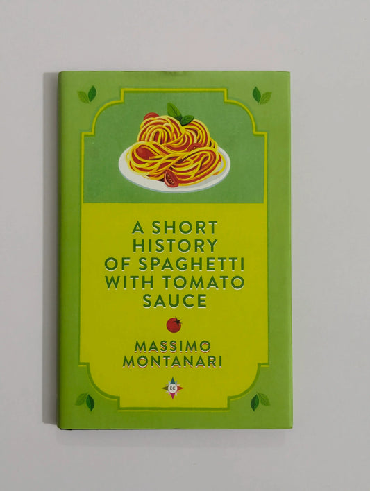 A book titled 'A Short History of Spaghetti with Tomato Sauce' by Massimo Montanari, featuring a bright lime green cover with an illustration of spaghetti on a plate at the top.