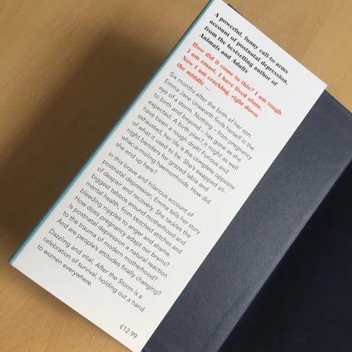 Book with a page open displaying text on a wooden surface