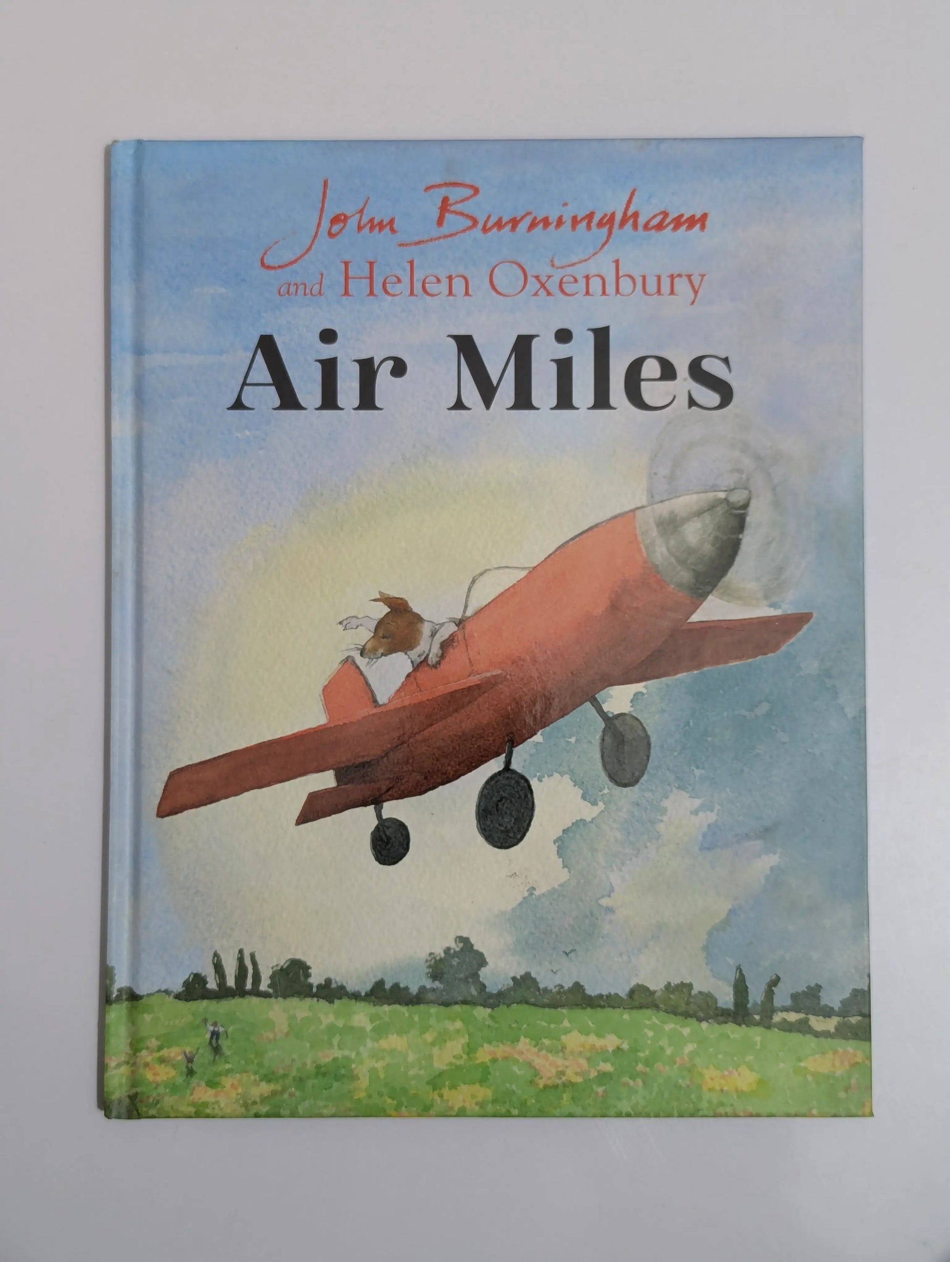 Book cover of 'Air Miles' by John Burningham and Helen Oxenbury with an illustration of a dog in an airplane.