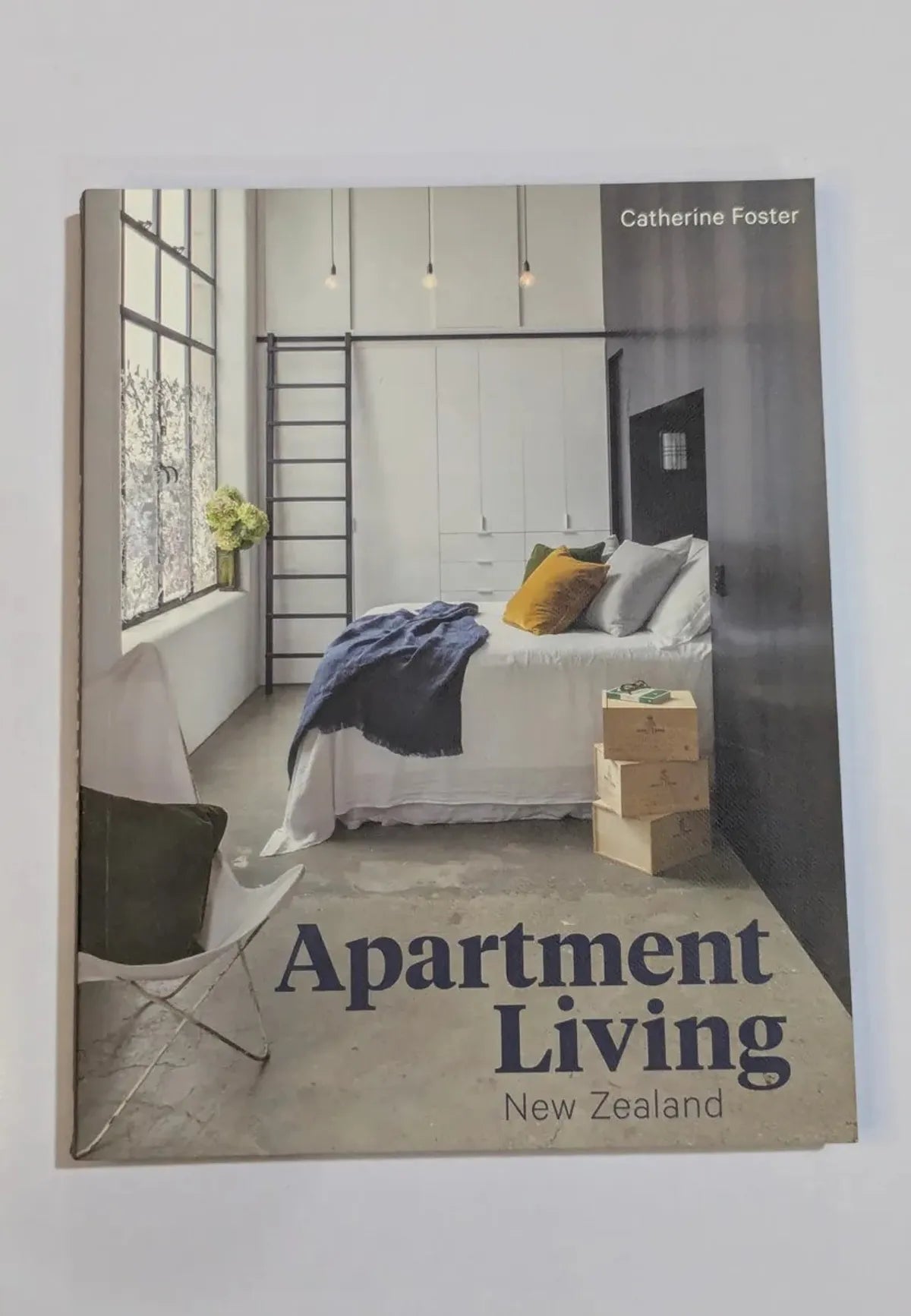 Book titled 'Apartment Living New Zealand' by Catherine Foster with a bedroom scene on the cover.