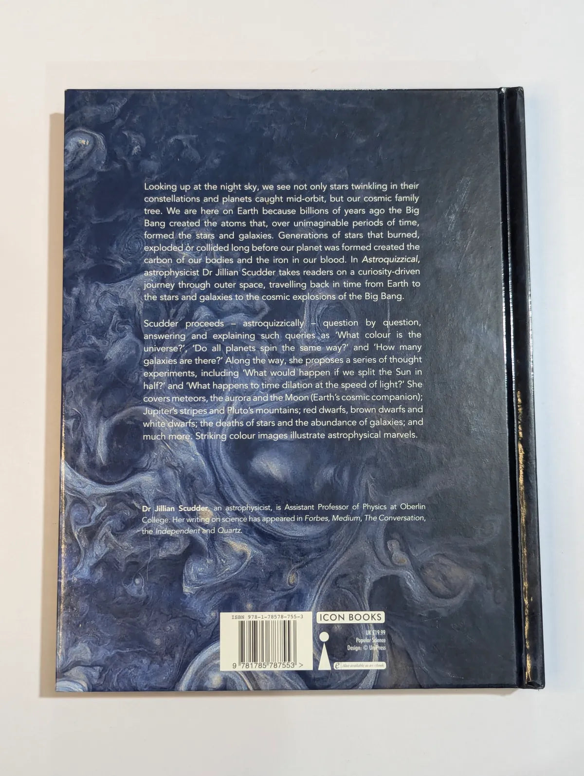 Back cover of a book with text and a marbled design on a white background