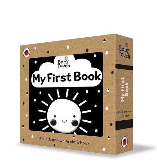 Box of 'My First Book' for babies with a black and white design on a beige background