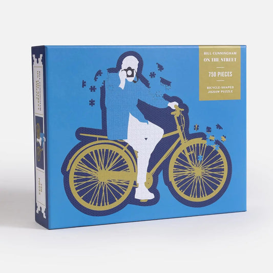 Jigsaw puzzle box with bicycle and person design on a blue background