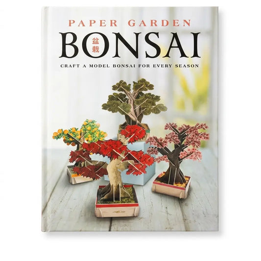 Paper Garden Bonsai book cover featuring four miniature paper bonsai trees in different colors, including red, pink, yellow, and green, arranged on a light wooden surface. The title 'PAPER GARDEN BONSAI' is printed at the top.