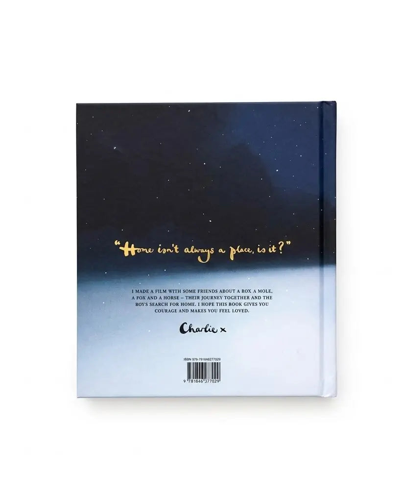 A hardcover journal shown from the back, featuring a dark navy starry sky gradient that fades to a light blue-white horizon. The cover has a gold foil quote, descriptive text, the brand name 'Charluxe', and a barcode.