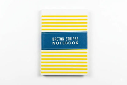 Notebook with yellow stripes and blue label on a white background