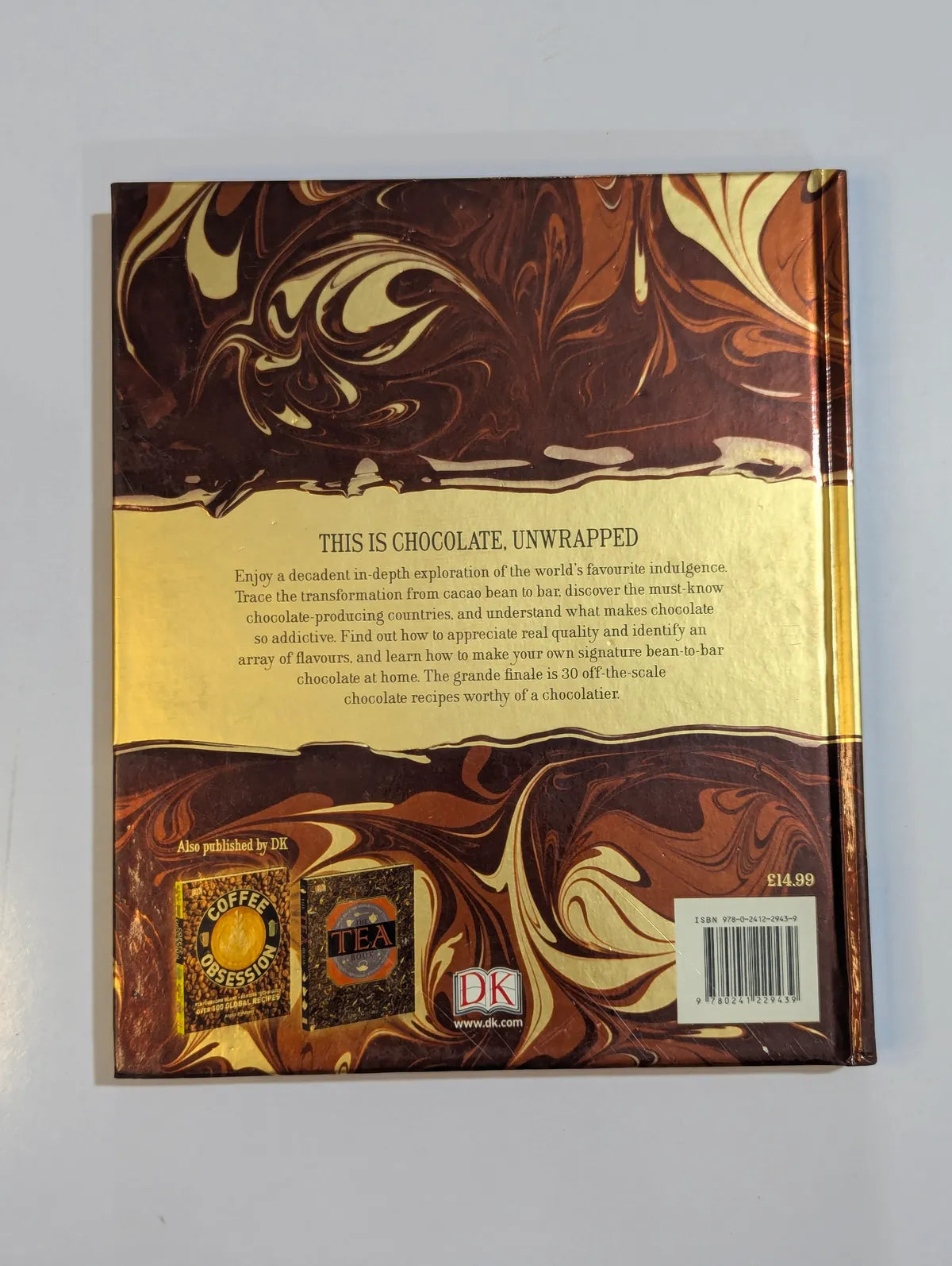 Chocolate packaging with marbled design and text on a gray background