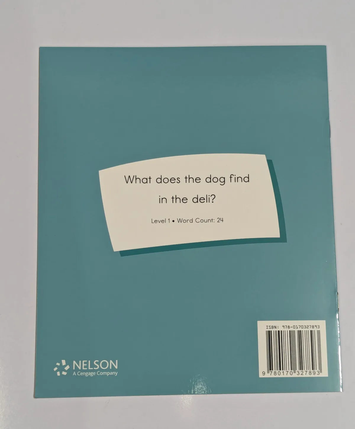 Teal book with a white label on a gray background