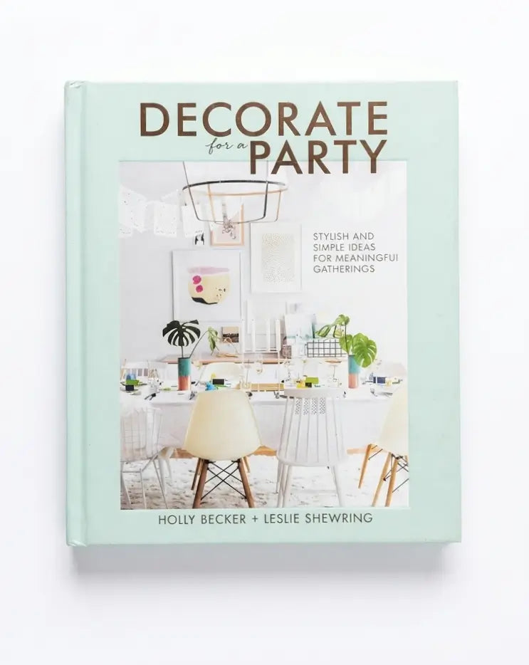 Decorate for Party book by Holly Becker and Leslie Shewring, featuring a mint green cover with a central dining room photograph.
