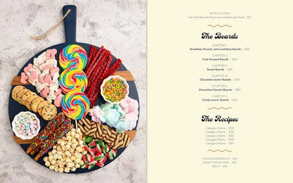 Assorted candies and cookies on a wooden board with 'The Boards' branding.