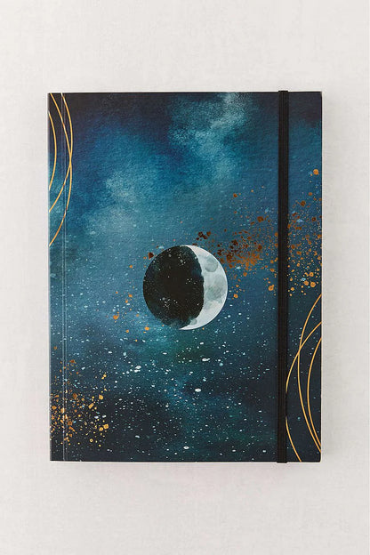 Notebook with celestial design featuring a moon and starry sky on a white background