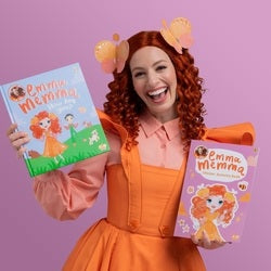 Woman in orange dress holding two 'Emma's Magic' books against a purple background