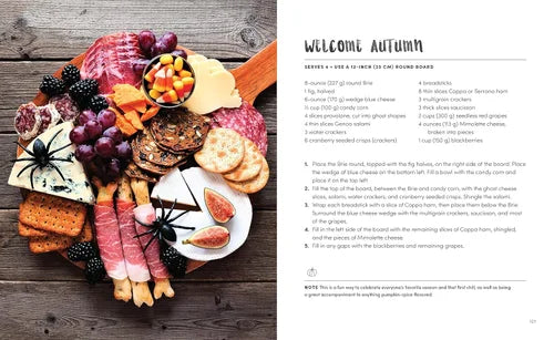 Autumn-themed charcuterie board with text on a wooden surface
