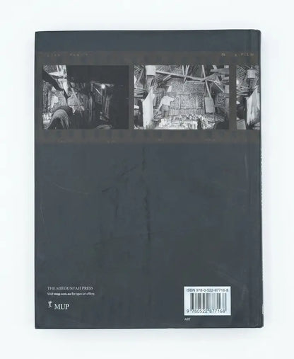 The back cover of a hardcover book titled 'The Axiom: Vision and the Art of Video' published by The Axiom Press, featuring three black-and-white documentary stills across the top and a barcode at the bottom right.