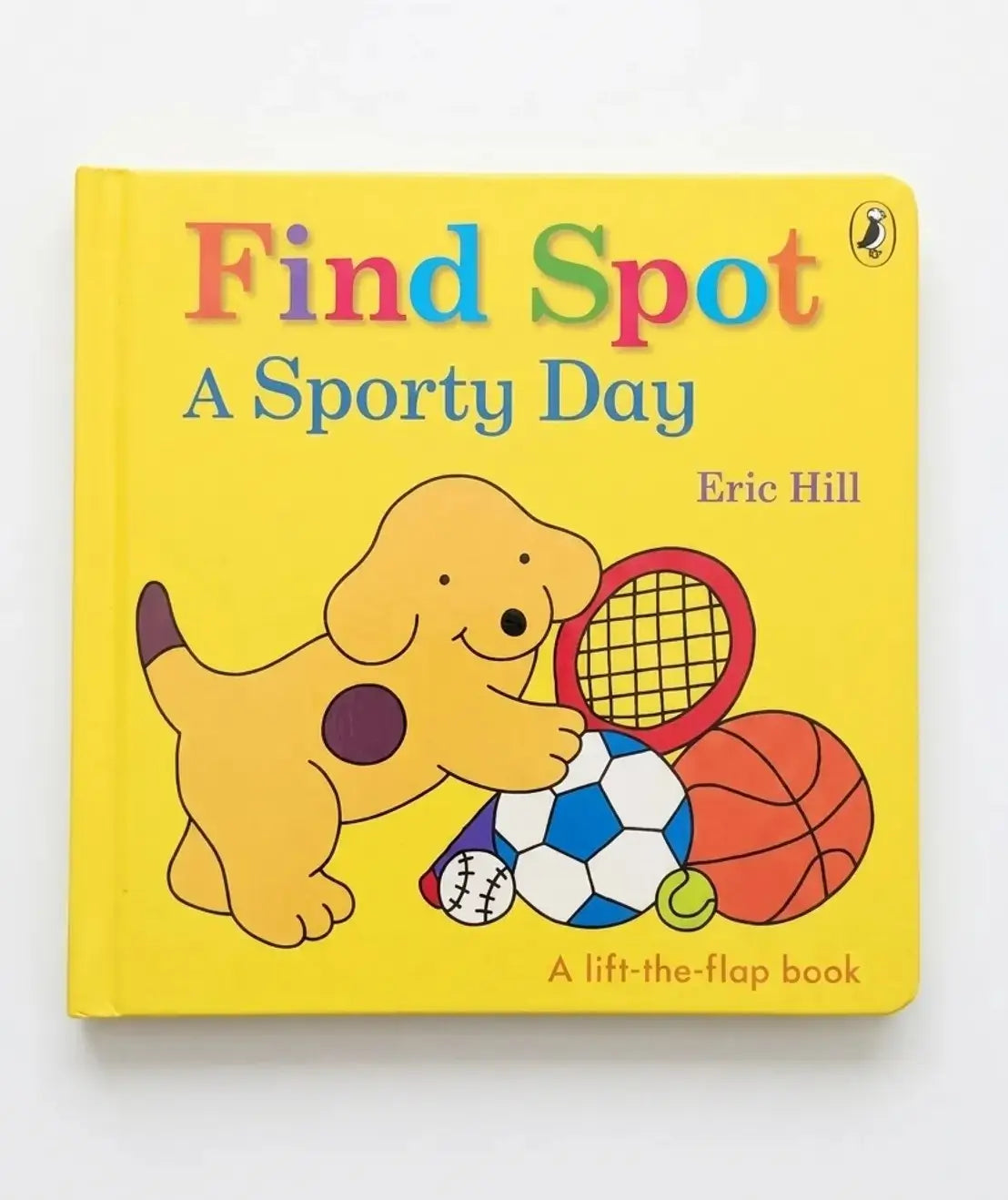 Children's book titled 'Find Spot: A Sporty Day' by Eric Hill with a yellow cover featuring a cartoon dog and sports equipment.