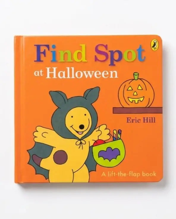 The front cover of the children's lift-the-flap book 'Find Spot at Halloween' by Eric Hill, published by Penguin. The cover features a bright orange background with a cartoon illustration of a yellow dog in a black bat costume holding a green bat-shaped bucket, next to a cartoon jack-o'-lantern.