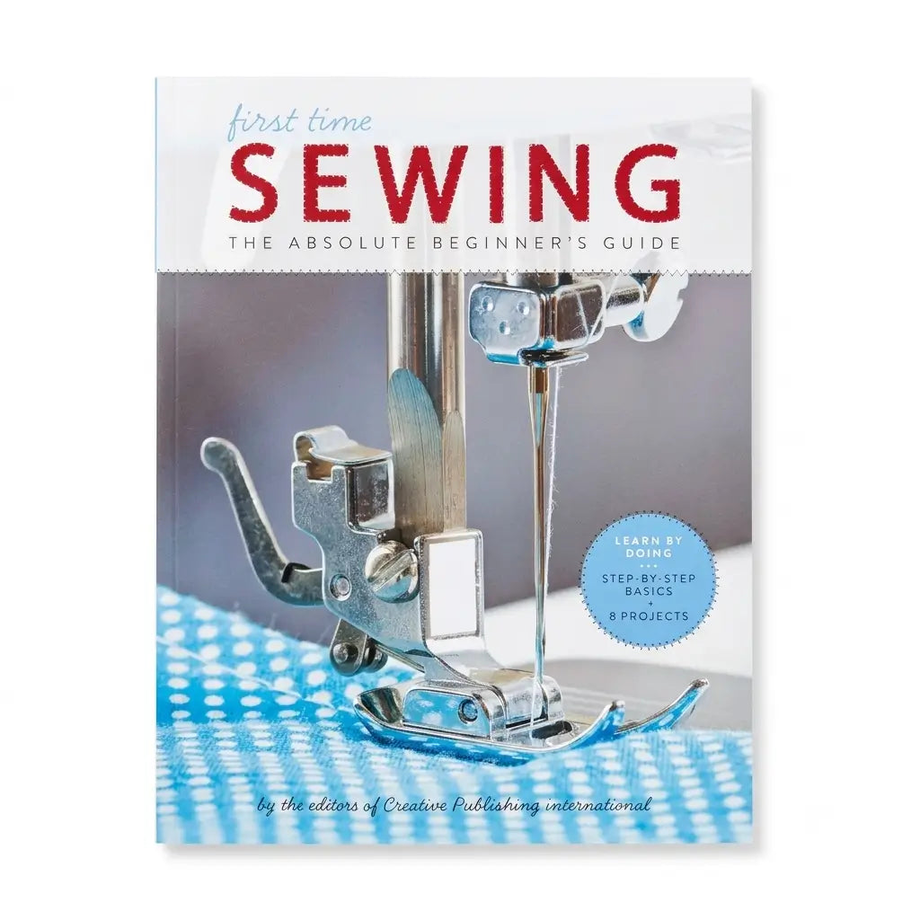 The book cover of 'first time SEWING: THE ABSOLUTE BEGINNER'S GUIDE' by Creative Publishing International, featuring a close-up photo of a sewing machine presser foot on a blue-and-white checkered fabric.