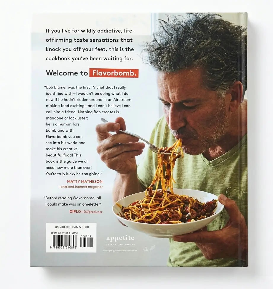 The back cover of the book Flavorbomb, featuring a large photograph of a man eating spaghetti from a bowl, with text reviews and a barcode on a white background.