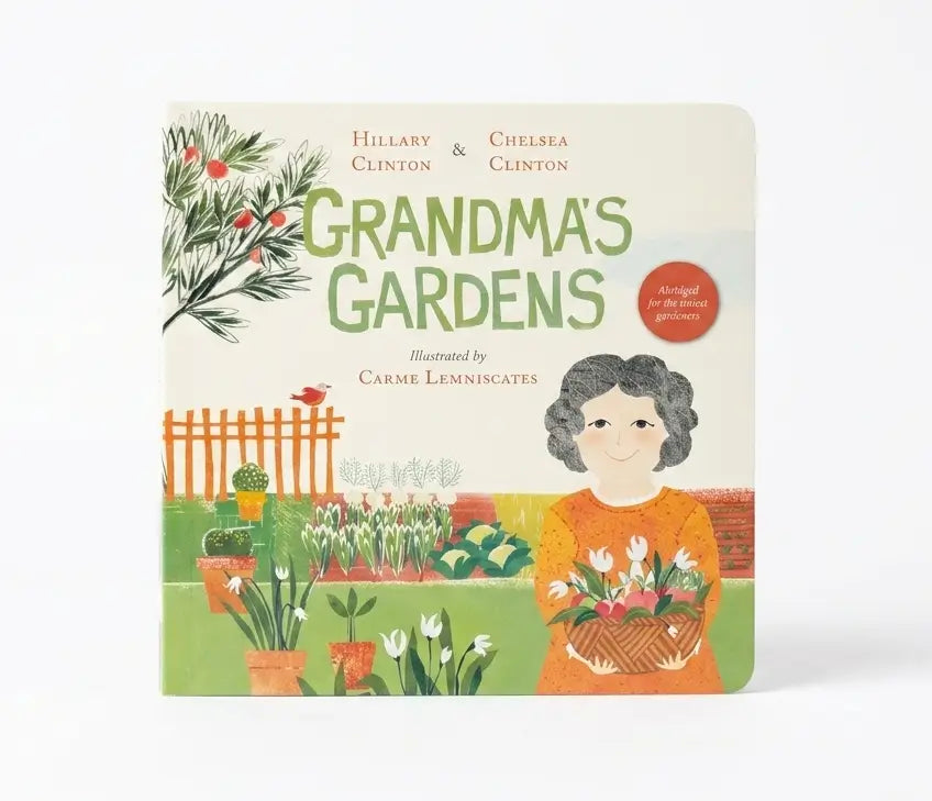 The front cover of the children's board book 'Grandma's Gardens' by Hillary Clinton and Chelsea Clinton, illustrated by Carme Lemniscates. The cover features a colorful, retro-style illustration of a woman in an orange dress holding a basket of flowers in a garden, with potted plants, a white picket fence, and green title text on a cream background.
