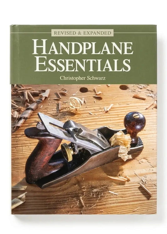 Handplane Essentials book by Christopher Schwarz, featuring an olive green top banner with white text and a cover photo of a hand plane on a wooden workbench with wood shavings.