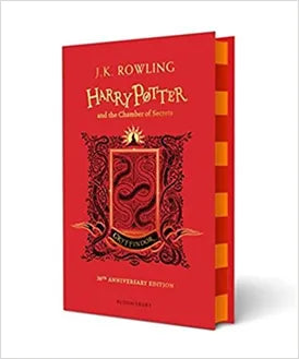 Red book cover of 'Harry Potter and the Chamber of Secrets' with decorative elements on a white background