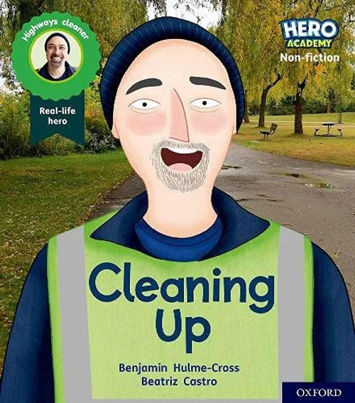 Book cover of 'Cleaning Up' by Hero Academy with a cartoon character in a high-visibility vest and real-life hero badge.