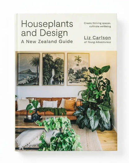Book cover for 'Houseplants and Design: A New Zealand Guide' by Liz Carlson of Young Adventures, featuring a warm-toned interior scene with potted plants, a sofa, and framed landscape prints.