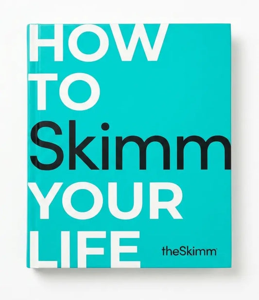The Skimm magazine cover, featuring a bright turquoise background with the title 'HOW TO Skimm YOUR LIFE' in large white and black sans-serif text, and the brand name 'theSkimm' in the lower right.