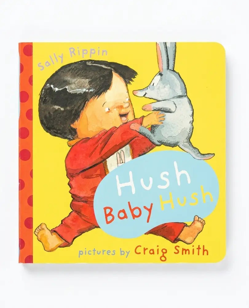 Book cover of 'Hush Baby Hush' with a child holding a possum against a yellow background