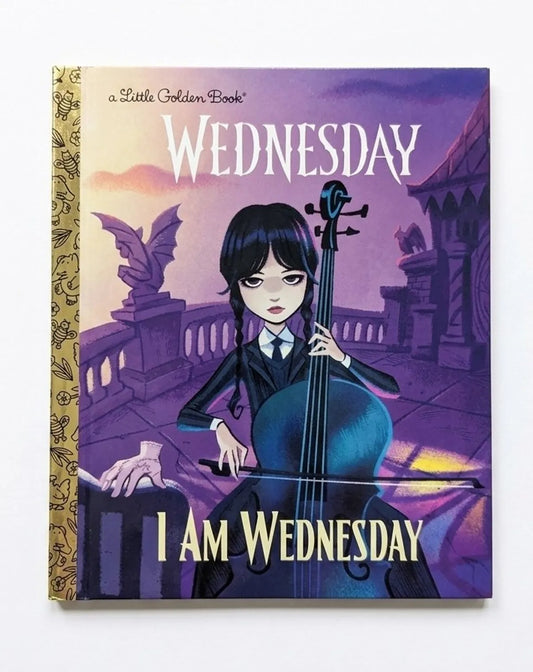 Book cover of 'I Am Wednesday' by Little Golden Book with a character holding a cello.