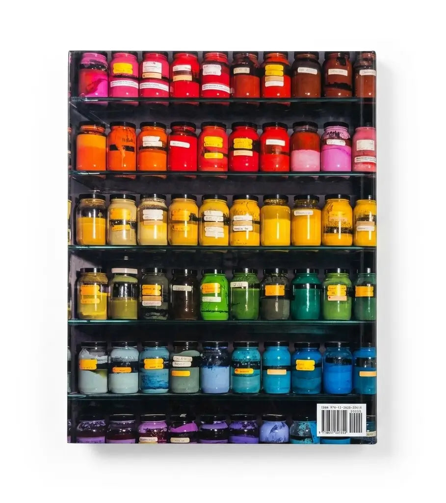 A rectangular product with rounded corners, likely a notebook, journal, or book, featuring a cover design of colorful candles arranged on black shelves against a white background.