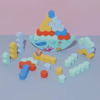 Colorful geometric block set on a light blue surface with a pink background