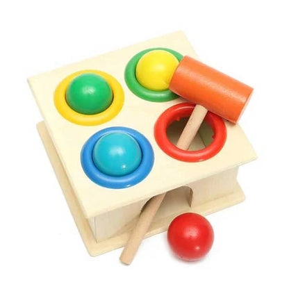 Colorful wooden toy with shape-sorting rings and a hammer on a white background