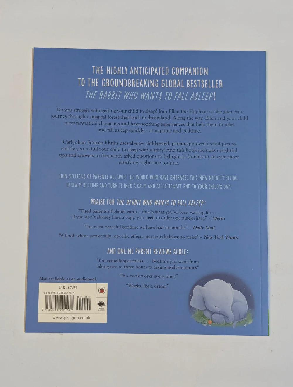 Back cover of a book with text and an elephant illustration on a gray background