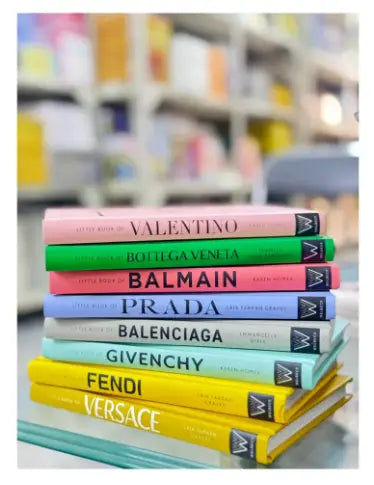 Stack of books with brand names on a blurred bookshelf background