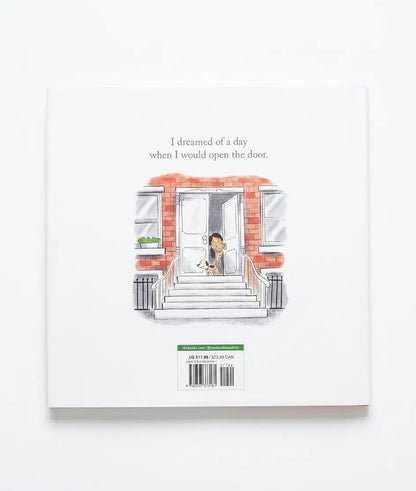 The back cover of a children's book titled 'I dreamed of a day when I would open the door.' shown against a clean white background.