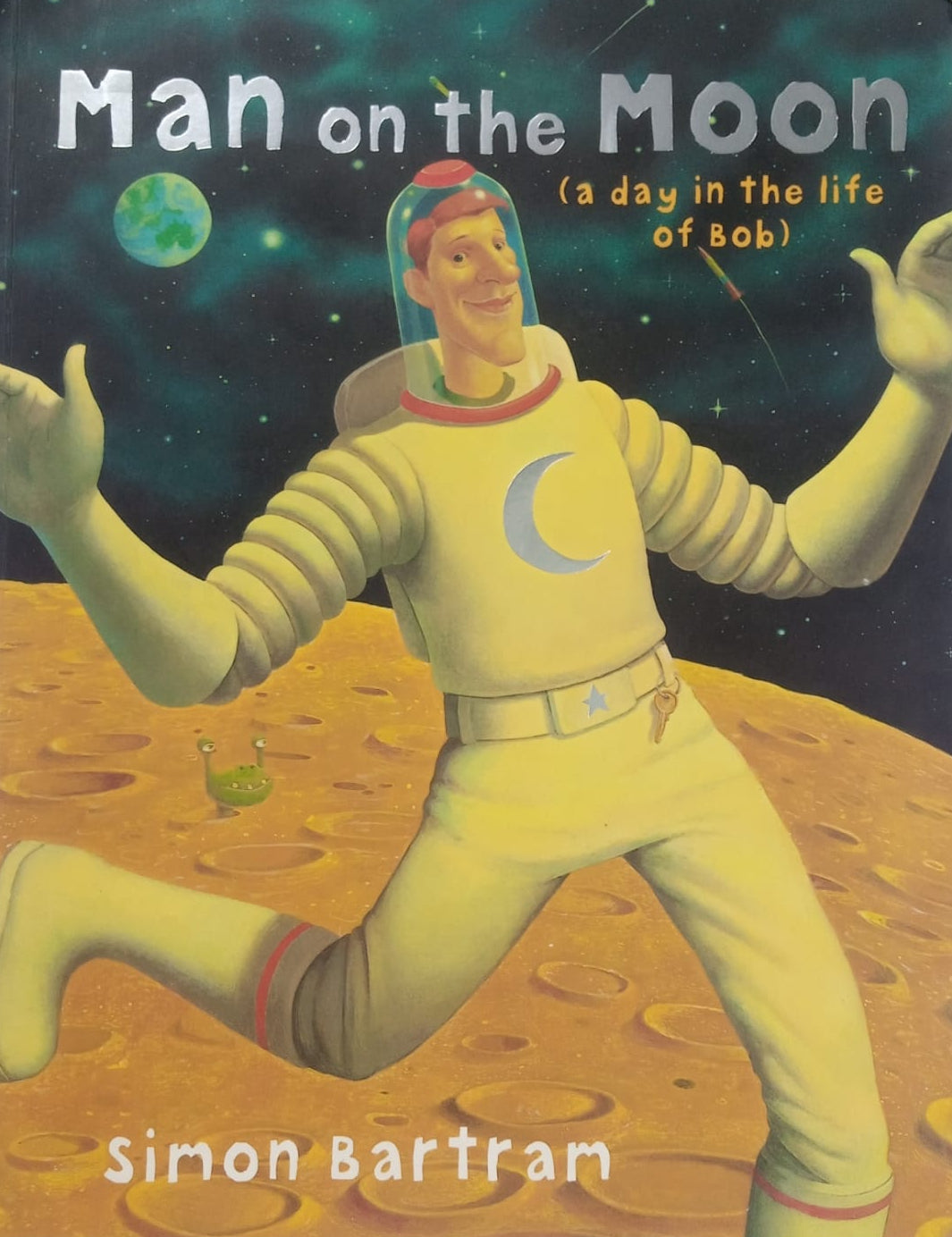 A preloved book cover titled 'Man on the Moon (a day in the life of Apollo)' by Simon Bartram, featuring an illustration of an astronaut on the moon's surface.