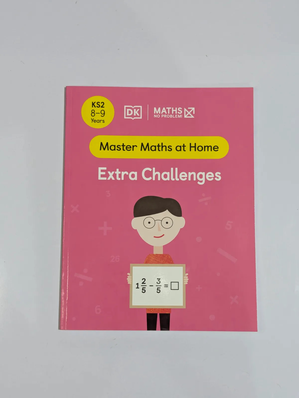 Book titled 'Master Maths at Home Extra Challenges' with a pink cover and DK logo on a gray background