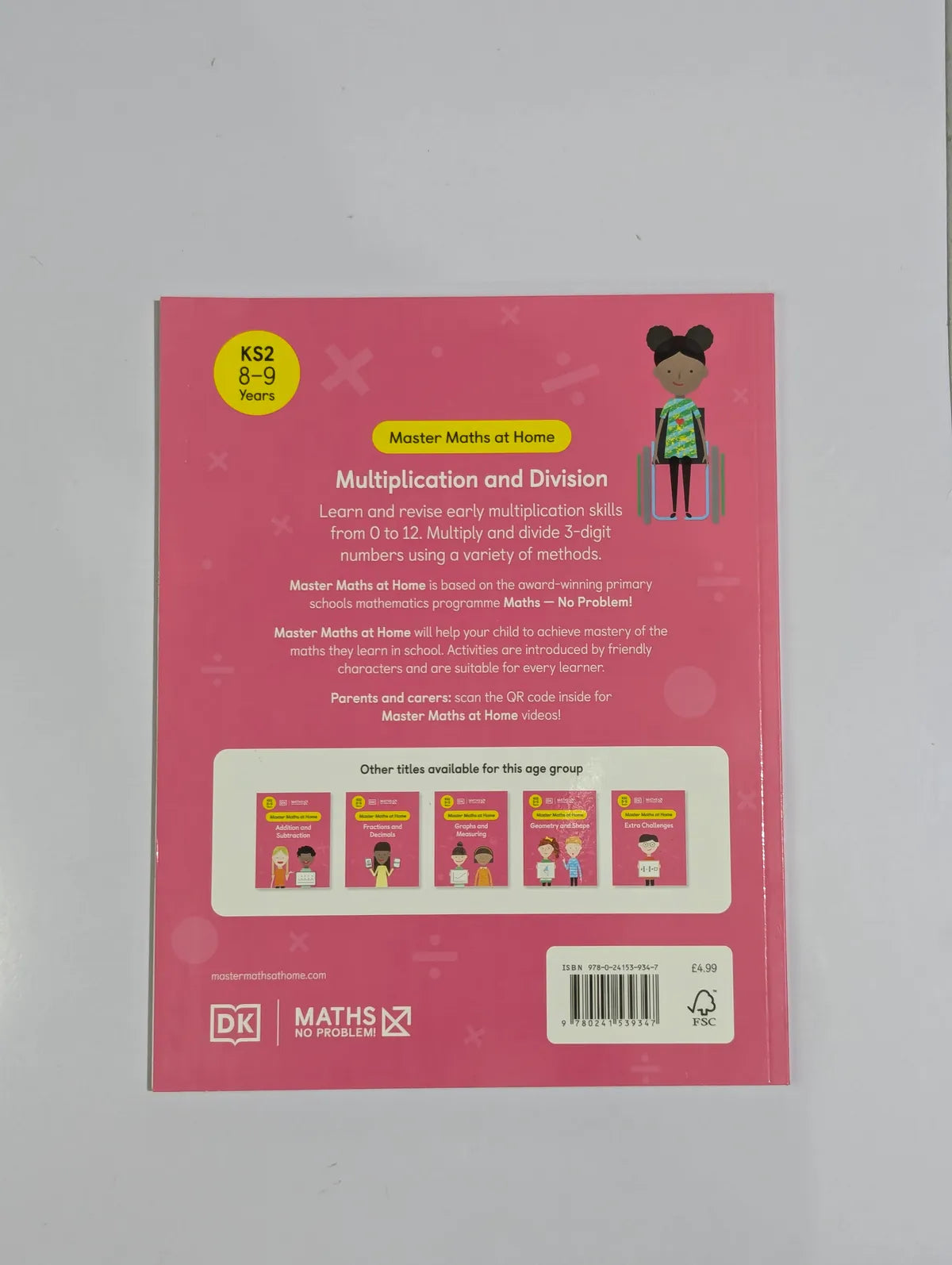 Back cover of a book with educational content on multiplication and division, featuring a child and text.