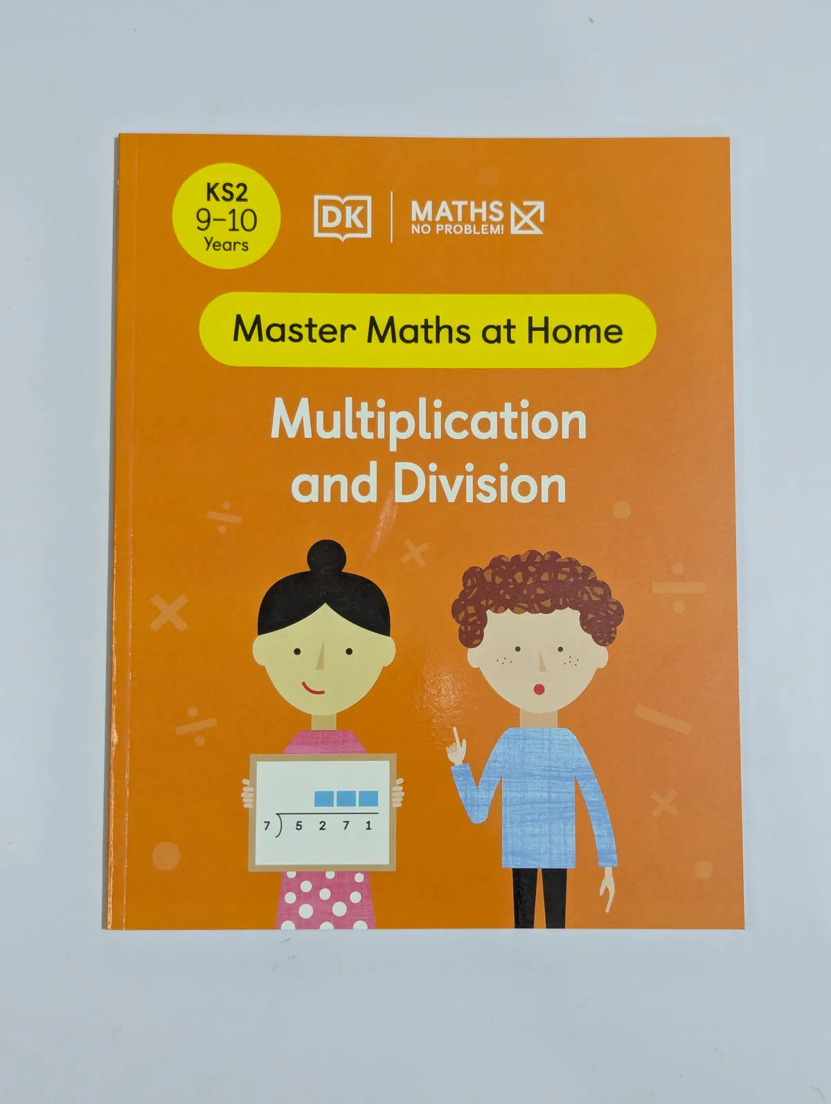 Book titled 'Master Maths at Home: Multiplication and Division' on a light gray background