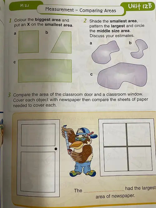 Educational worksheet on comparing areas with a cartoon character and classroom illustrations.
